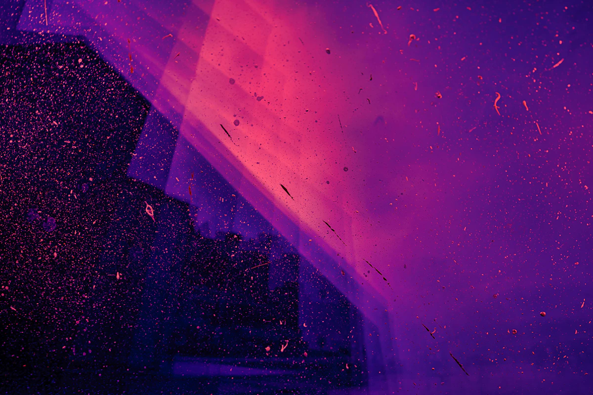 Abstract purple and magenta gradient with diagonal light streaks and fine speckled texture